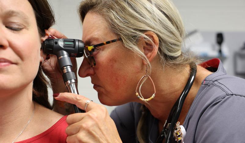 michelle bigger-wiegard checking patient's ears